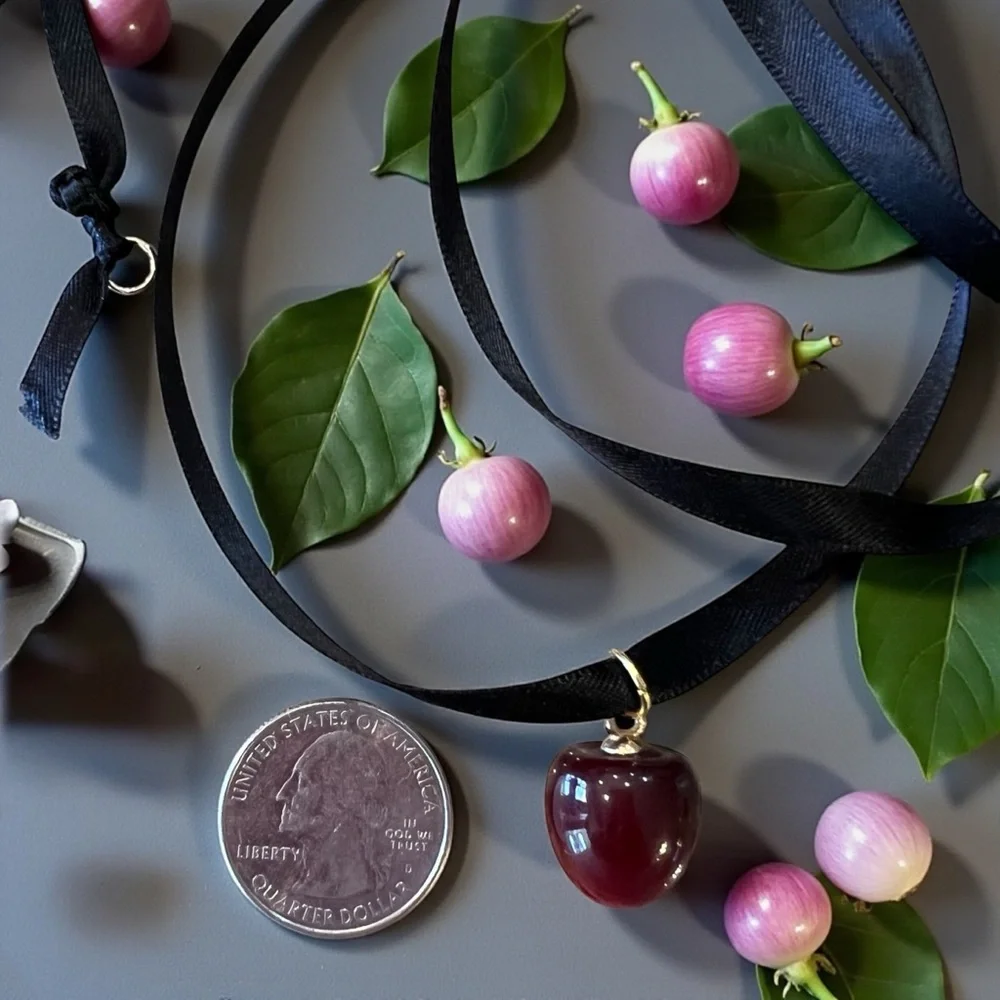 Satin ribbon choker necklace featuring an apple/cherry pendant